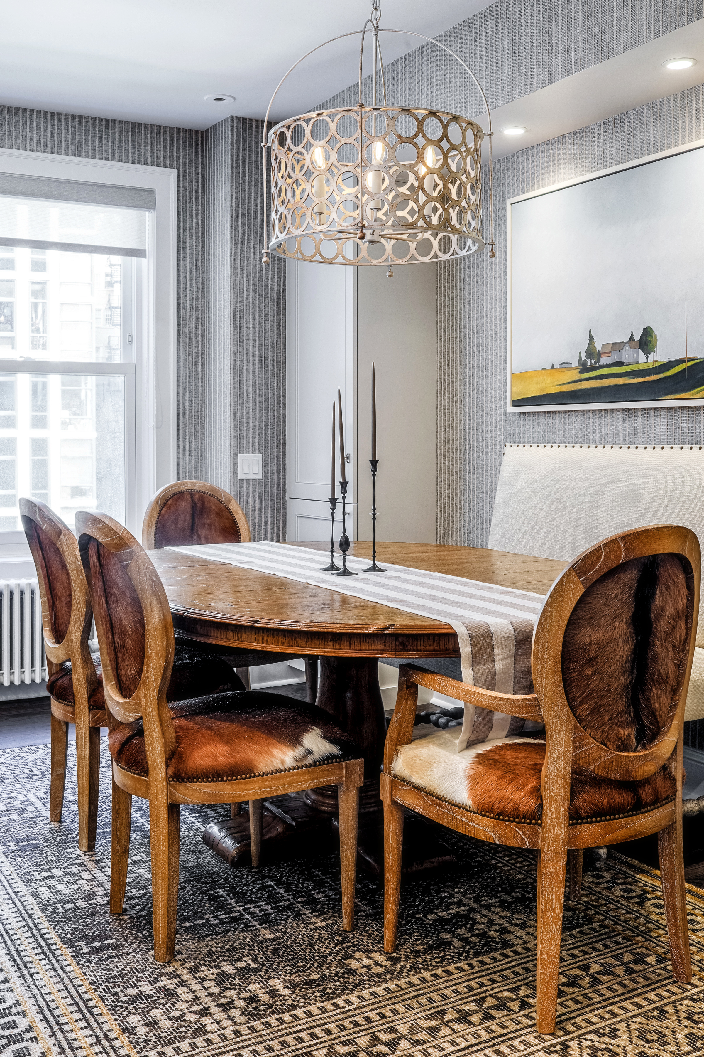 wooden dining table with candlesticks and hanging lamp